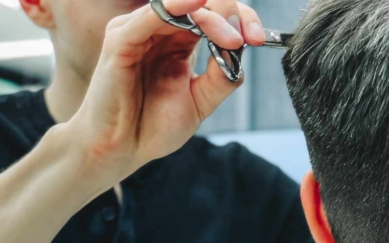 Barber styling a client's hair