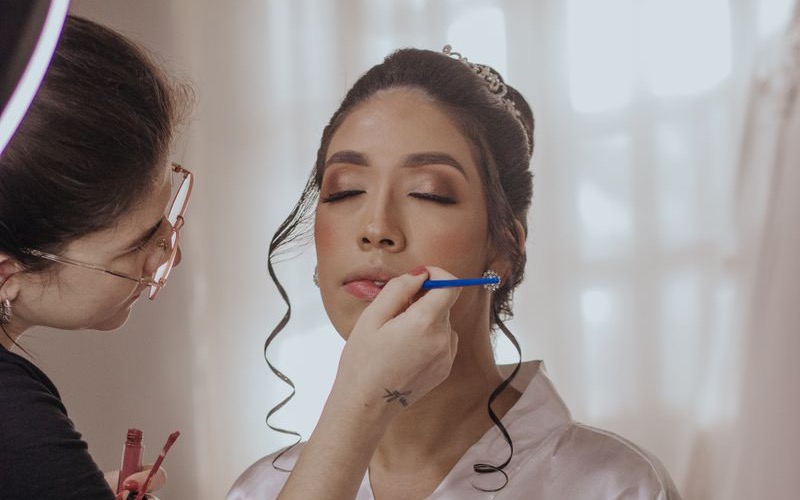 Makeup artist applying bridal makeup